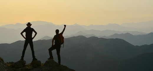 silhouette of person on mountain top