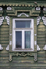 Gingerbread wood trims. Decorated window of an old wooden house
Beautiful wood carving