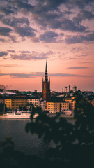 Fototapeta na wymiar Riddarholmen church with pink sunset colors. Stockholm, Sweden.
