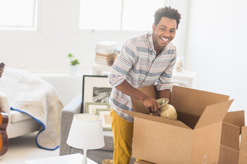 Man packing decors into cardboard box
