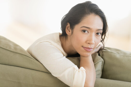 Portrait of young woman sitting on couch