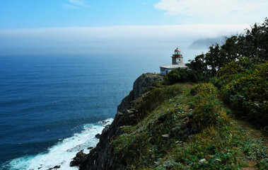 Fototapeta na wymiar Old lighthouse located on the Pacific ocean. Beautiful scenery on a Sunny day.