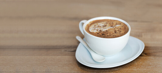 hot cappucinno serve on wood table