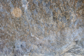 Granite stone wall texture. Background rock backdrop with rough abstract grunge textured surface of stony material nature detail of rocks.