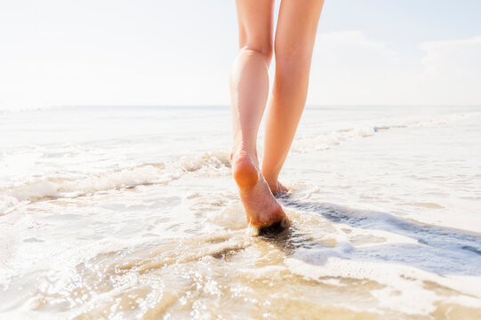 Legs of woman walking in sea