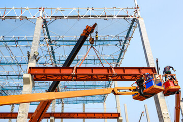 Construction workers installation steel structure girder runway beam lifting by mobile crane and placing on corbel of column concrete at the construction site project © Sumith Nunkham