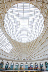 Fototapeta premium Architectural ceiling of Corn Exchange market in Leeds, England with people in the lower part of the picture. 