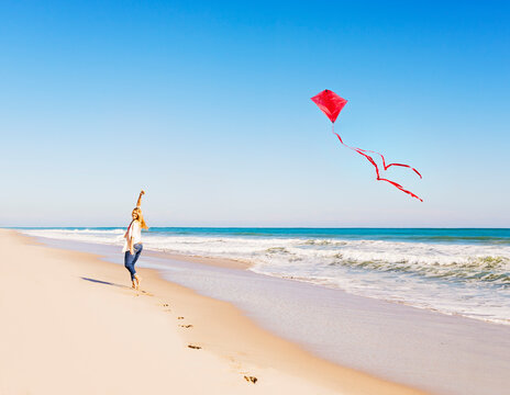 Woman on beach with kite