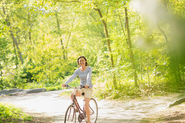 Mid adult woman riding bicycle