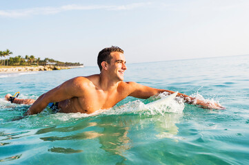 Young surfer paddling