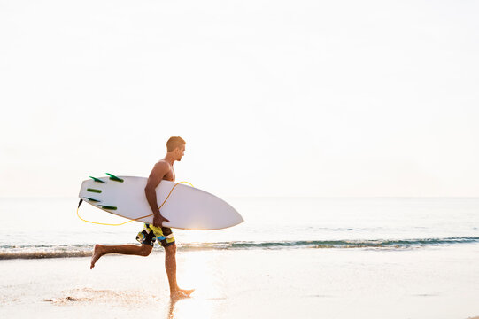 Side-view of surfer running
