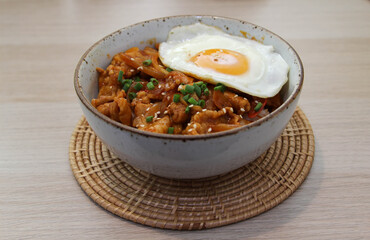 Fried pork with kimchi and fried egg with rice.