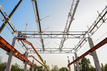 Steel structure roof truss frame erection by mobile crane under at the construction building in the factory site project