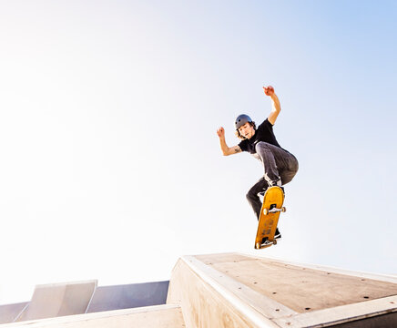 Man jumping on skateboard in skatepark