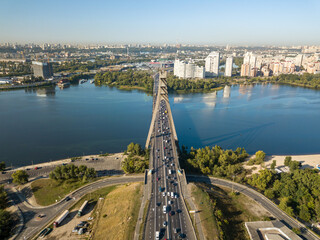 Obraz premium Aerial drone view. Automobile North Bridge in Kiev across the Dnieper River. Sunny day.