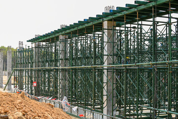 Construction scaffolding for support structure building second beam and second floor at construction site