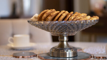 Sweet cookies in a glass vase, close-up. Blurred background.
