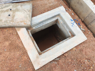 SEREMBAN, MALAYSIA -AUGUST 6, 2020: Utility services manhole and underground pipes under construction at the construction site. In-situ construction by workers based on infrastructure engineer design.