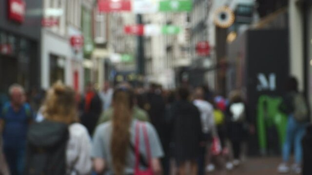 people walking on amsterdam central street defocused