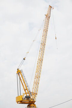 Crane against cloudy sky