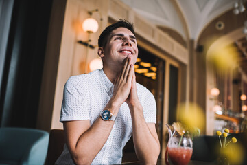 Happy man daydreaming in cafe