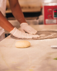 person kneading dough