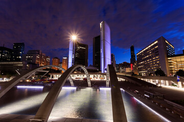 Illuminated skyline with empty ice rink in foreground