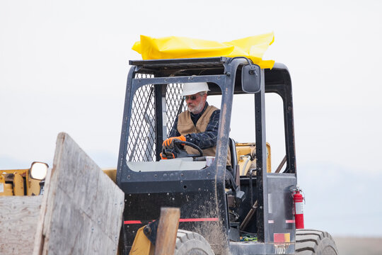 Senior man working on earthmover