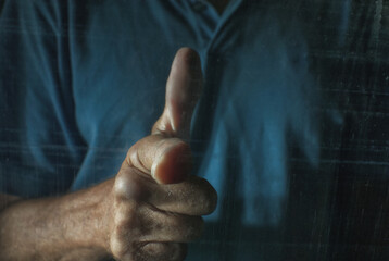 Hand emulating a gun outside of a car.