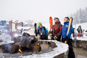 Group of friends with bonfire in winter