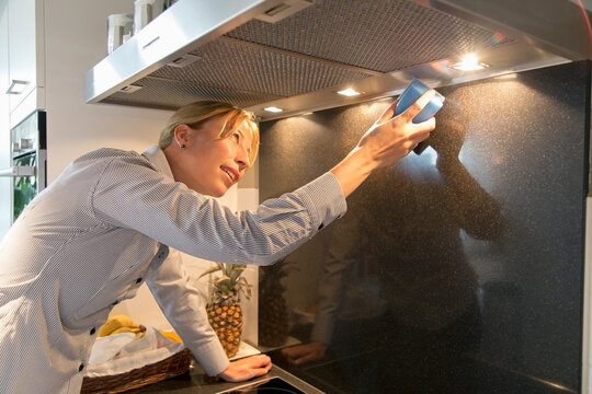 Woman cleaning kitchen