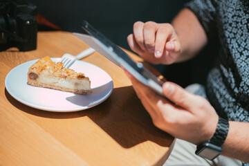 business man touching a tablet screen while eating a pie. stock market.