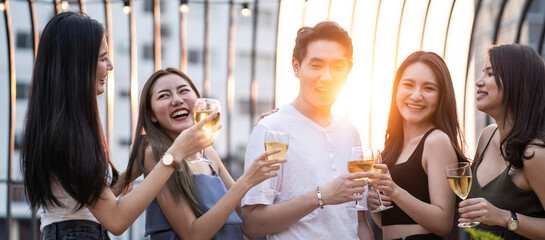 Group of Asian young man and woman holding wine glass and enjoy party.