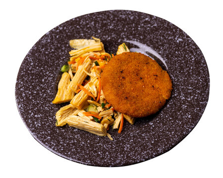fishcake with soy asparagus and carrots, cucumbers and dilll. fish cutlet on a plate isolated. cutlet with vegetables top view