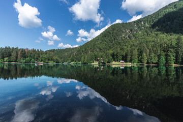 UDINE (ITALY) - APRIL 20, 2020: Superior Fusine Lake with Mount Mangart on the background. Fusine Lakes Natural Park, Tarvisio, Udine province, Friuli Venezia Giulia, Italy.