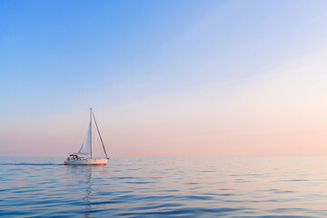 Sailboat in sea in the evening sunlight before sunset in Mediterranean sea, Spain with copy space on background