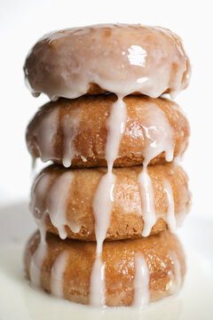 Stack of donuts with fresh glaze, white background