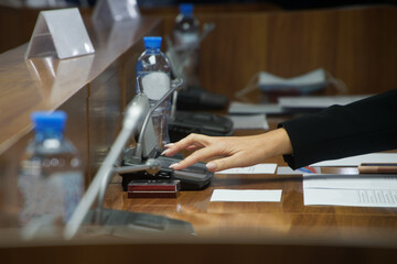Hand of a woman voting during a political meeting. Parliamentary lawmaking.