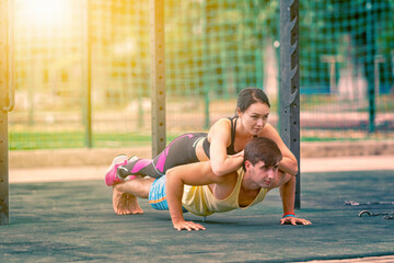 Young couple doing push-ups in tandem