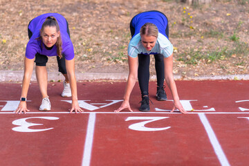Two young woman preparing for a race