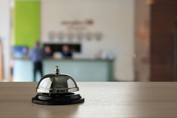 Hotel service bell on wood counter background