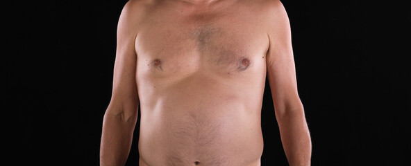 naked torso of a man on a black background