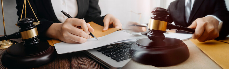 Business and lawyers discussing contract papers with brass scale on desk in office. Law, legal services, advice, justice and law concept picture with film grain effect