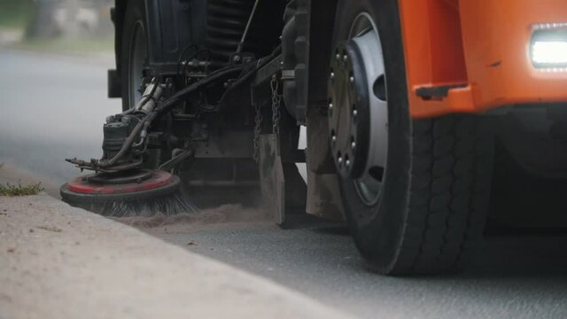 Machine clears the side of a road with a sweeper