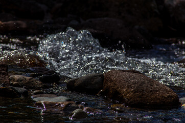 in summer rocky mountain river water silk. mountain river