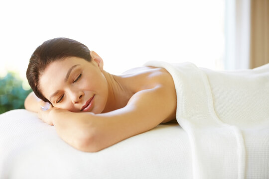 Beautiful Woman With Eyes Closed Lying On Massage Table