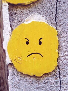 Yellow face painted in a wall