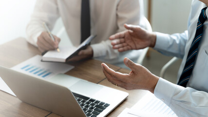 Business colleagues coaching with sales report at workplace.