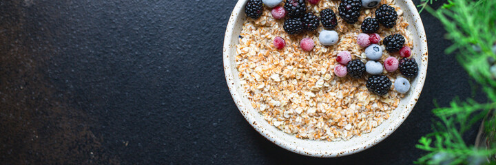 fresh oatmeal granola porridge
berries in plate tasty breakfast portion on the table top view copy space place for text food background rustic keto or paleo diet