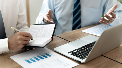 Business colleagues coaching with sales report at workplace.